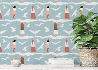 Seagull wallpaper with terracotta accents behind a green potted plant.