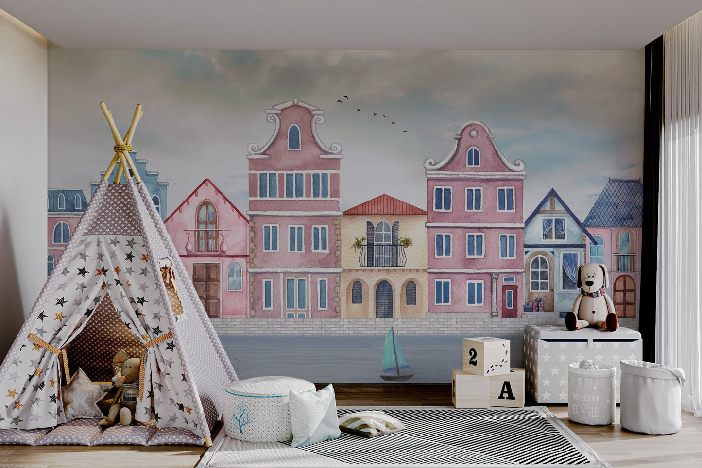Seaside town mural featuring pink, blue, and beige homes  for kids play area.