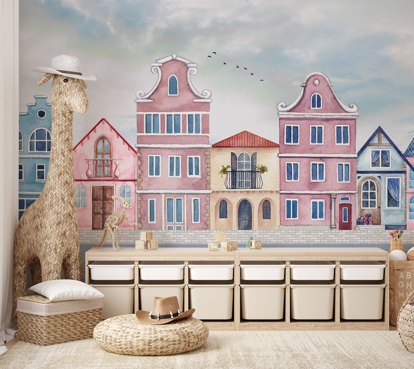 Watercolor townscape mural with birds in a cloudy sky for a play room.