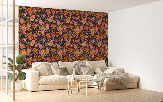 Large scale paisley wallpaper behind a cream sectional sofa in a living area.