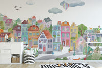 Colorful cityscape wall mural with pastel town houses wallpaper.