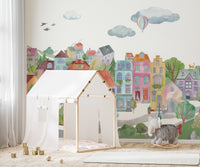 Artistic cityscape buildings wall mural with muted color wash.