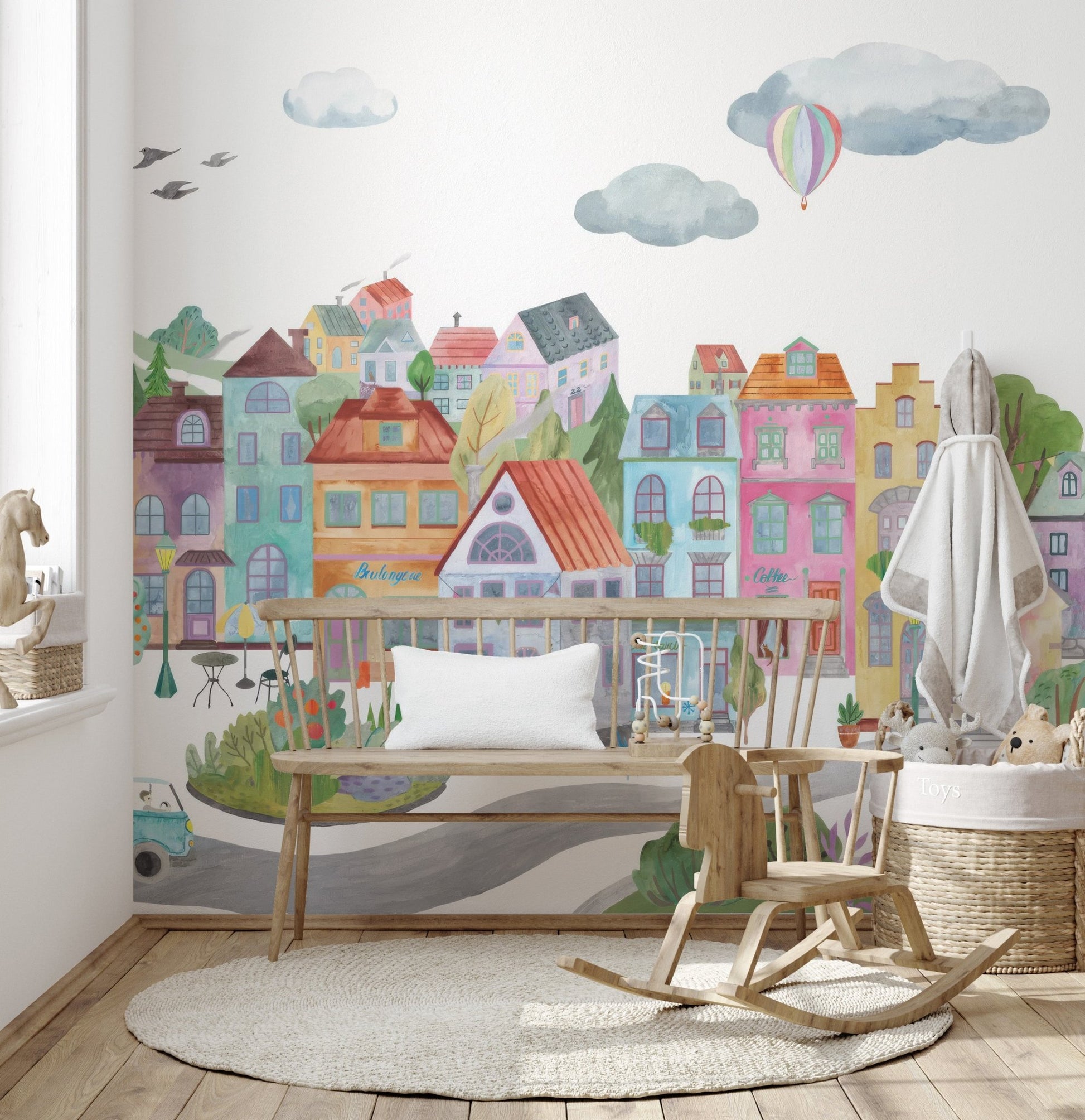 Whimsical city illustration wall mural with soft color palette.