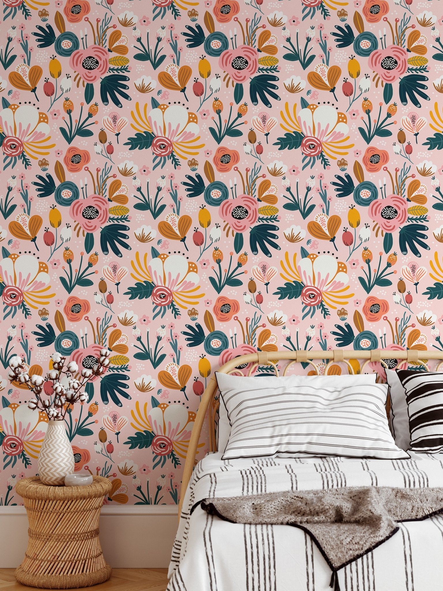 Floral pattern wallpaper on bedroom wall with white bedding and wooden side table.