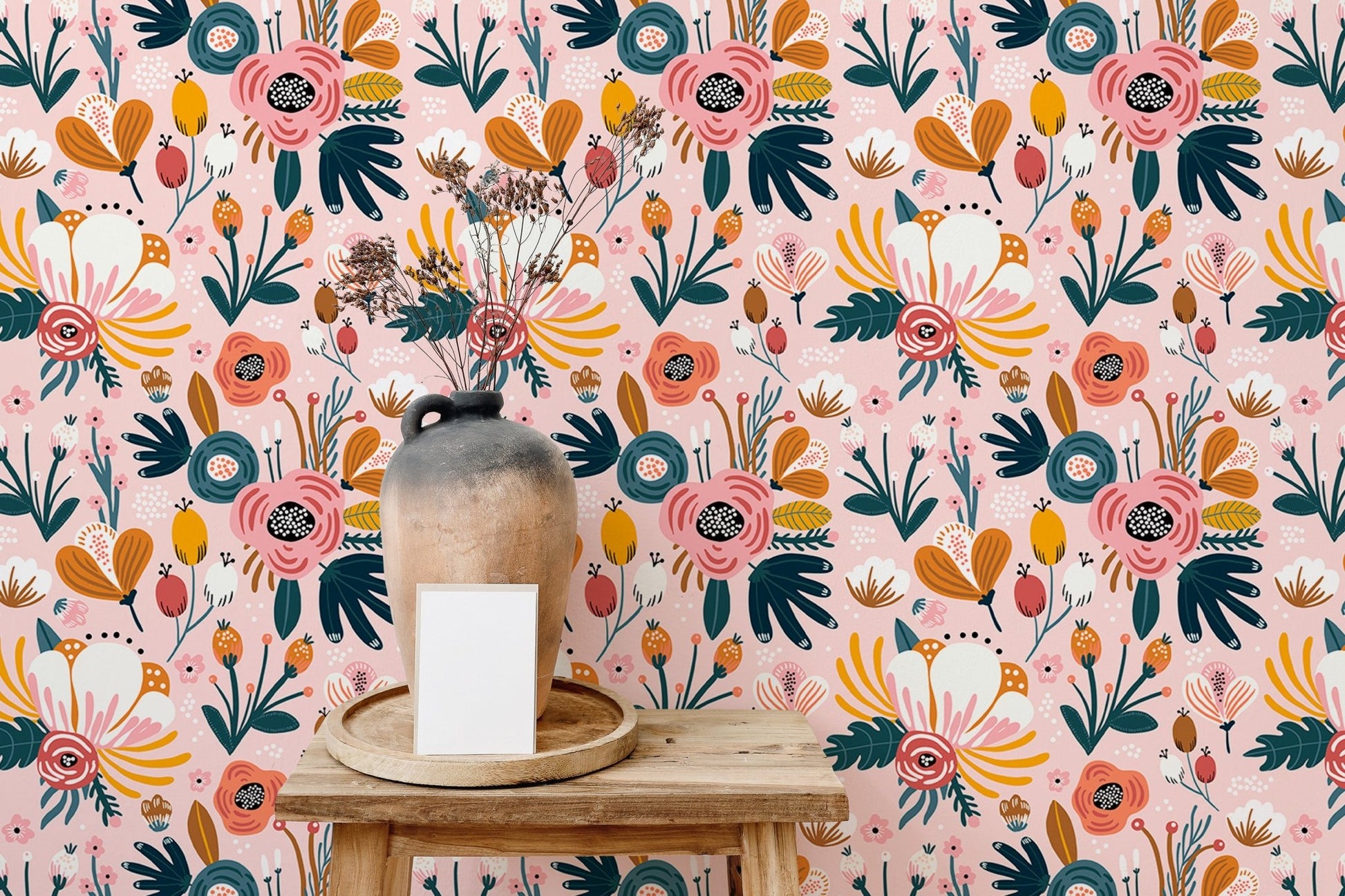 Pink floral wallpaper accent wall in room with table and vase.