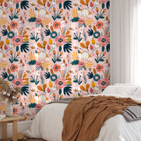 Pink background floral wallpaper behind a minimalist bed with white pillows.