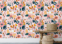 Pink background floral wallpaper styled with wooden furniture.
