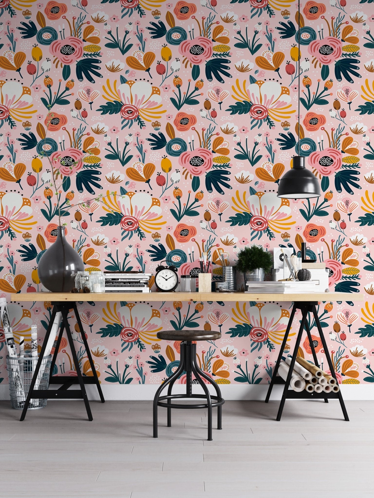 Seamless floral pattern wallpaper behind a work bench with black stools.