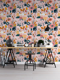 Seamless floral pattern wallpaper behind a work bench with black stools.
