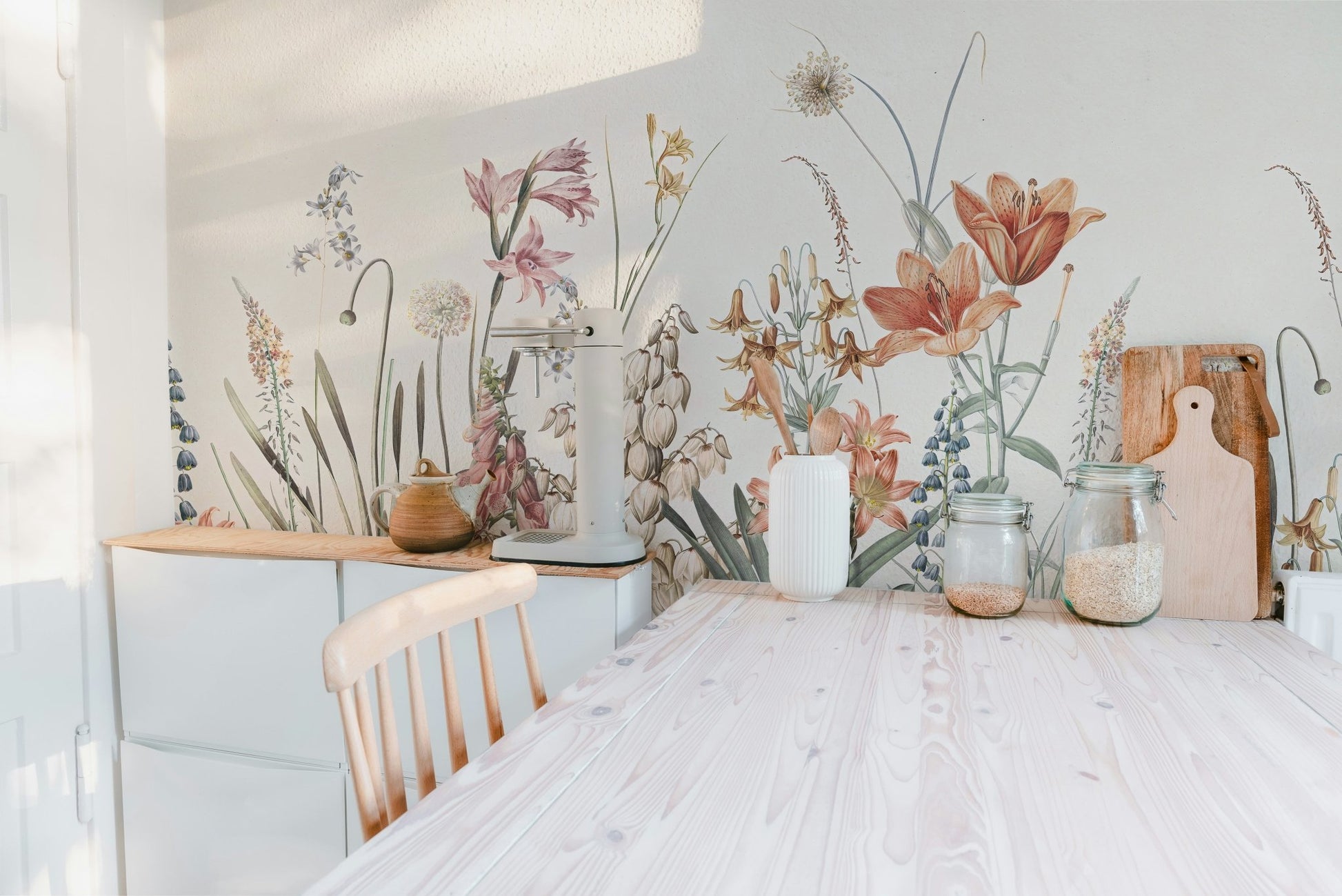 Floral beige background mural behind wooden dining set.