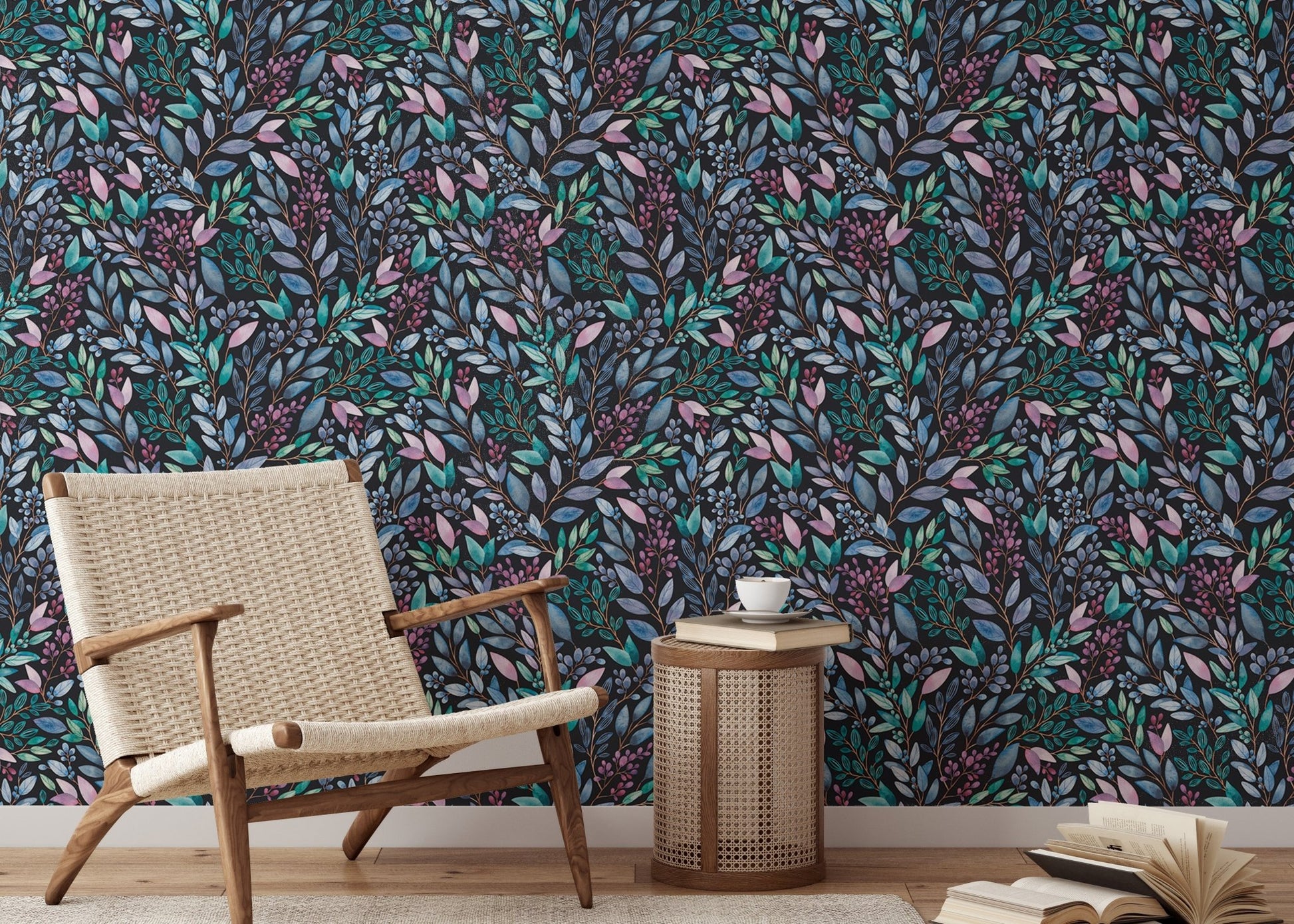 Dark botanical leaves wallpaper in a minimalist room with a tan leather chair.