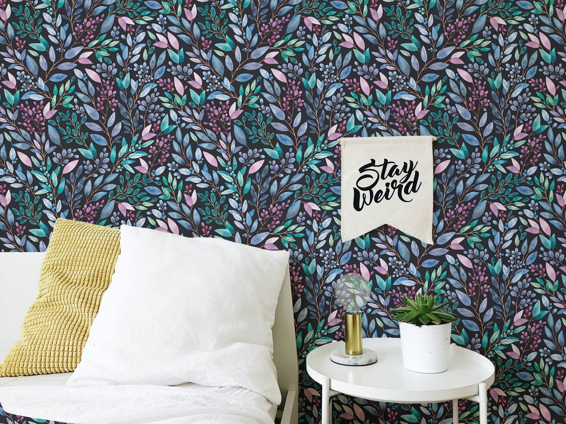 Colorful flowers wallpaper in a bedroom setting with white pillows and a side table.