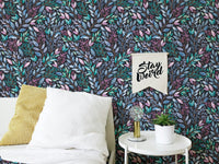 Colorful flowers wallpaper in a bedroom setting with white pillows and a side table.