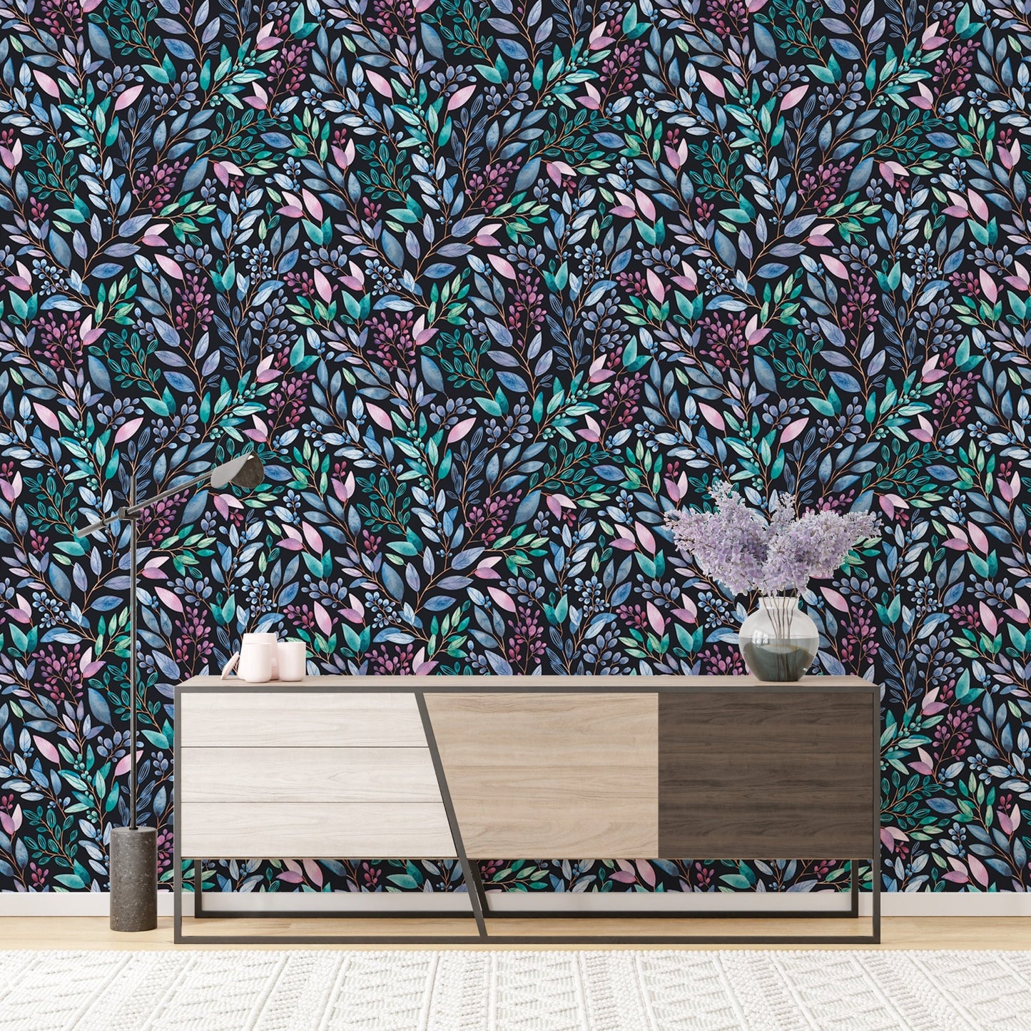 Patterned leaves wallpaper behind a mid-century modern wooden sideboard.