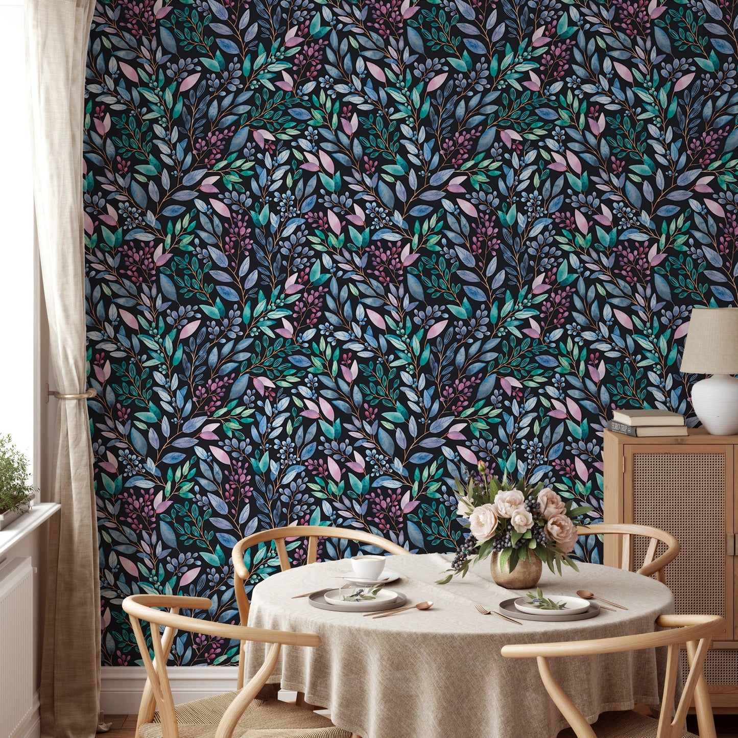 Detailed flower wallpaper behind a round dining table and wooden chairs.