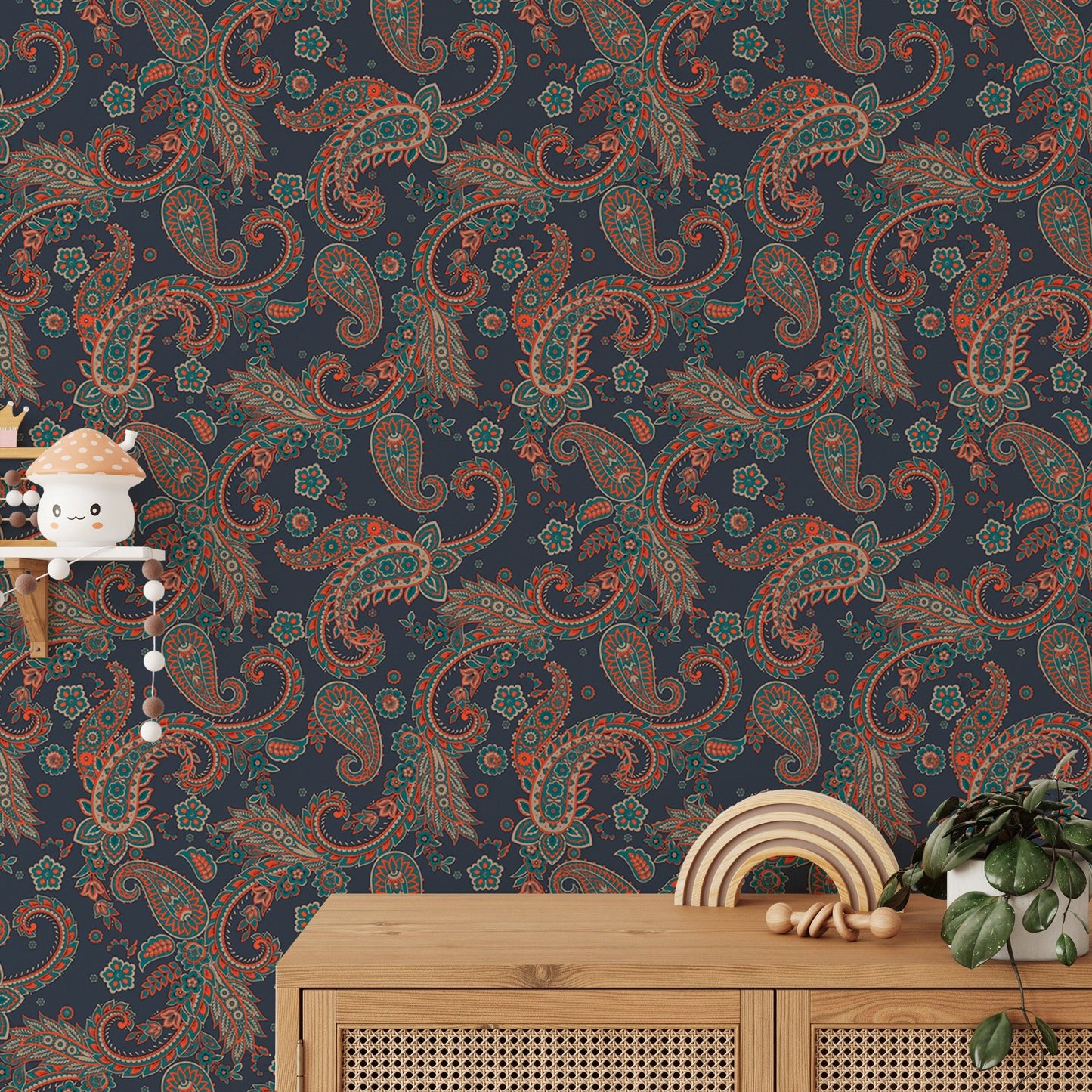 Blue paisley wallpaper set behind a wooden console table with small decor items.