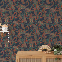 Blue paisley wallpaper set behind a wooden console table with small decor items.