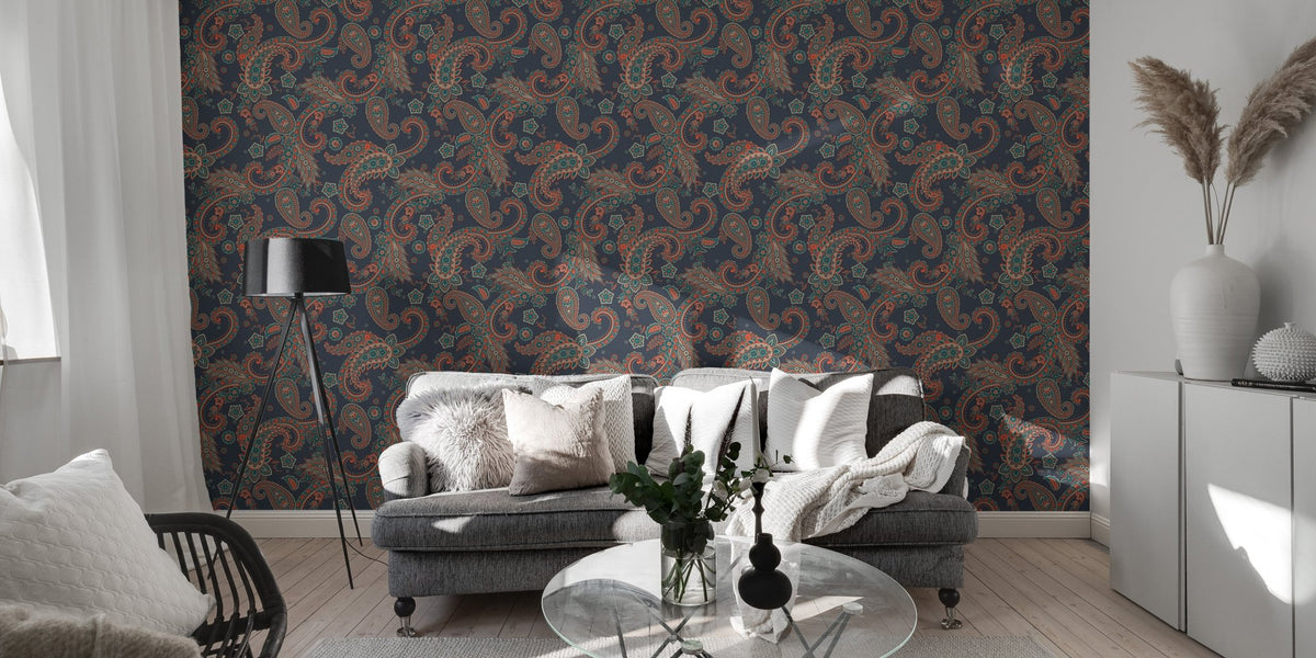 Dark blue seamless wallpaper with kalamkari elements behind a modern grey sofa.