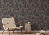 Wallpaper featuring seamless paisley shapes in reading room with a mid-century chair.
