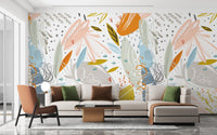 Luxury apartment living room with large scale leaf wall mural behind sectional.
