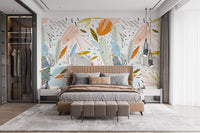 Spacious bedroom design with neutral tones and artistic leaf wall mural.