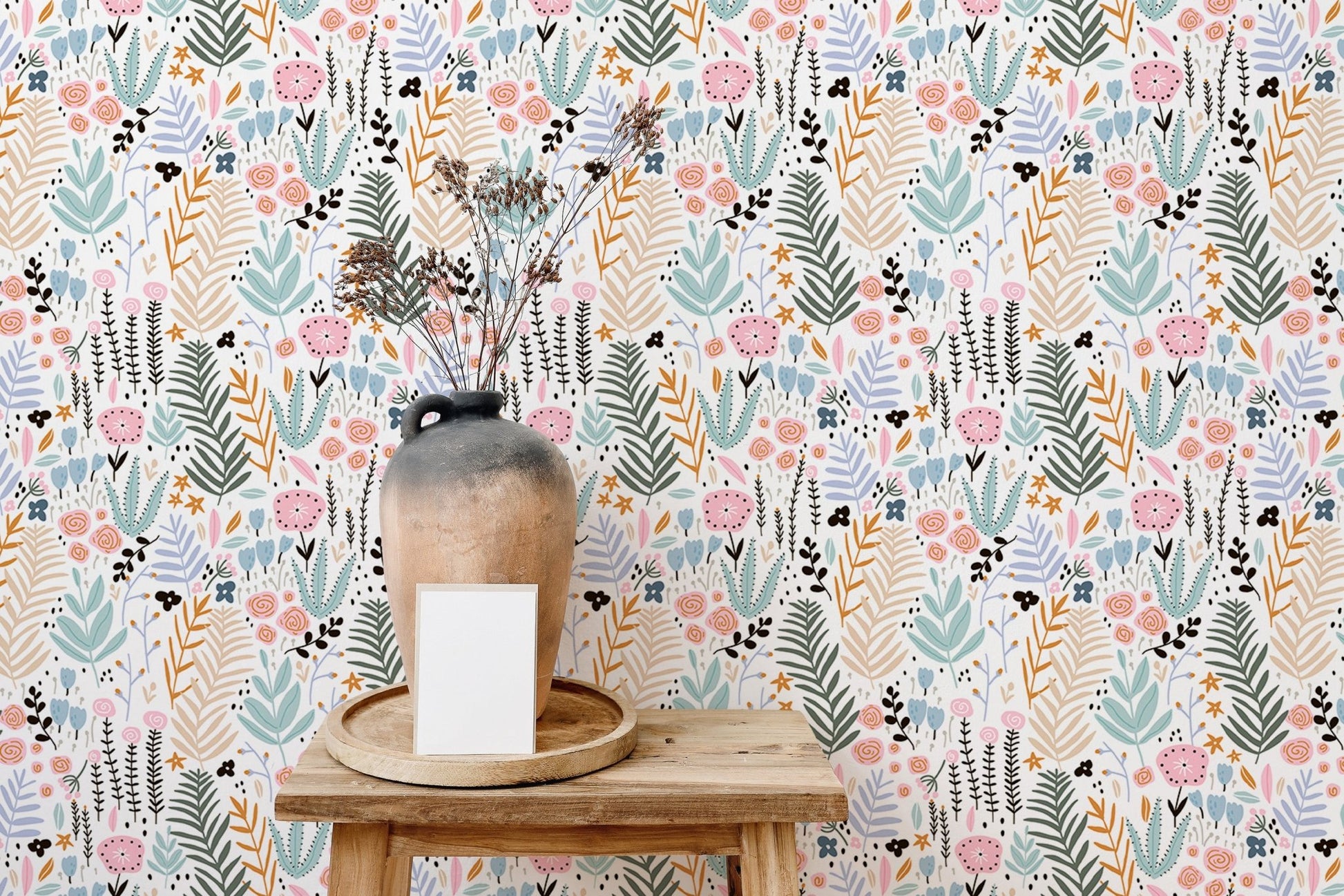 Wooden shelf against botanical print wallpaper with pink and blue floral accents.