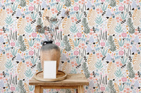 Wooden shelf against botanical print wallpaper with pink and blue floral accents.