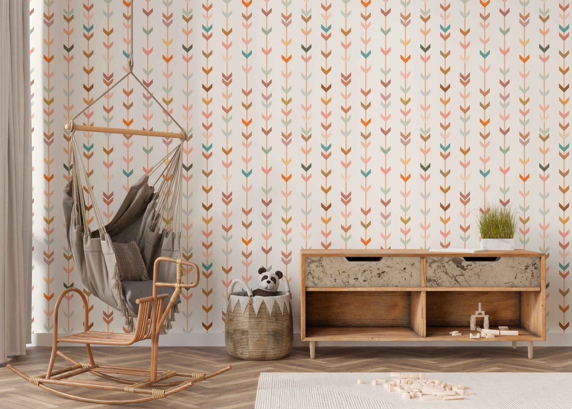 Vertical v-shaped elements on wallpaper in a living room with rocking chair.