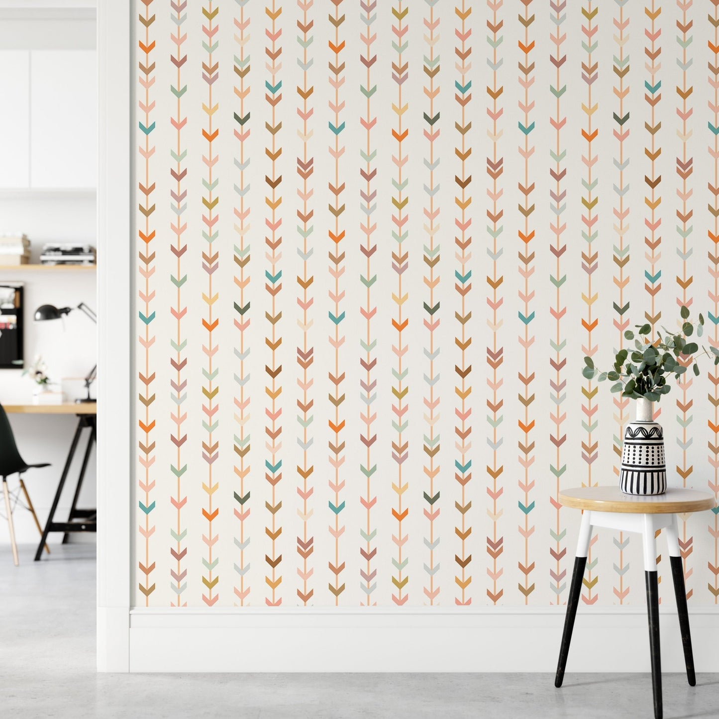 Bright hallway with geometric wallpaper and a white side table.