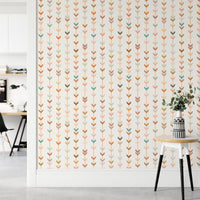 Bright hallway with geometric wallpaper and a white side table.