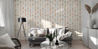 Grey sofa set against a wallpaper with repeating small geometric shapes.