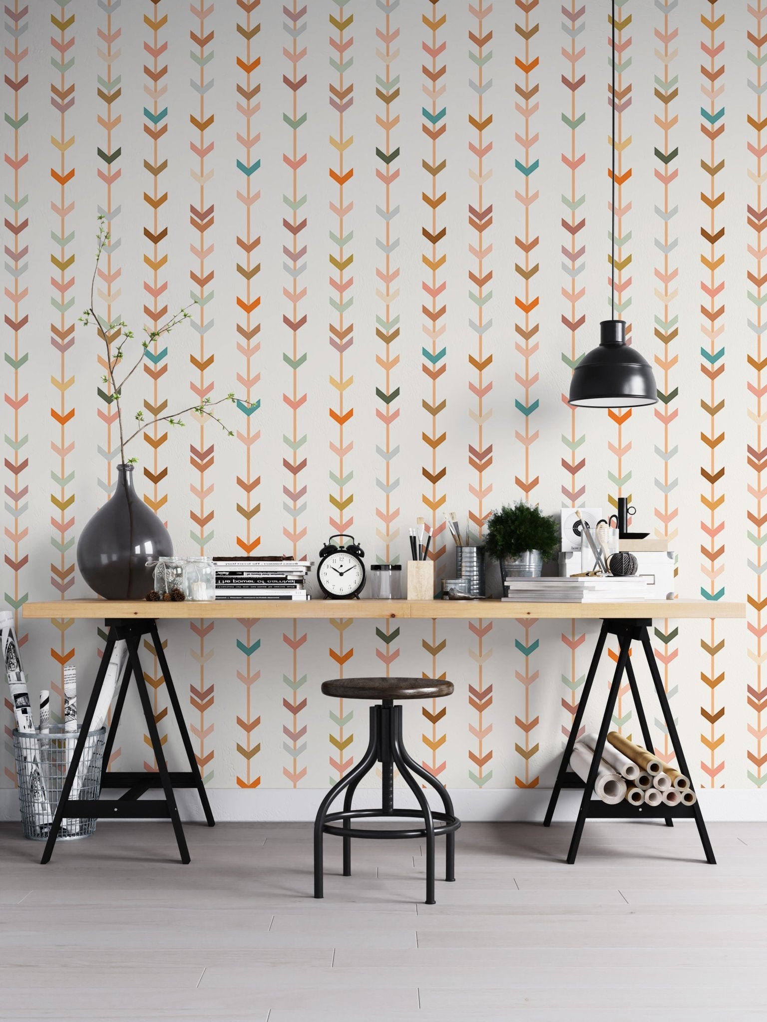 Home office workspace showing geometric wallpaper and a black desk lamp.