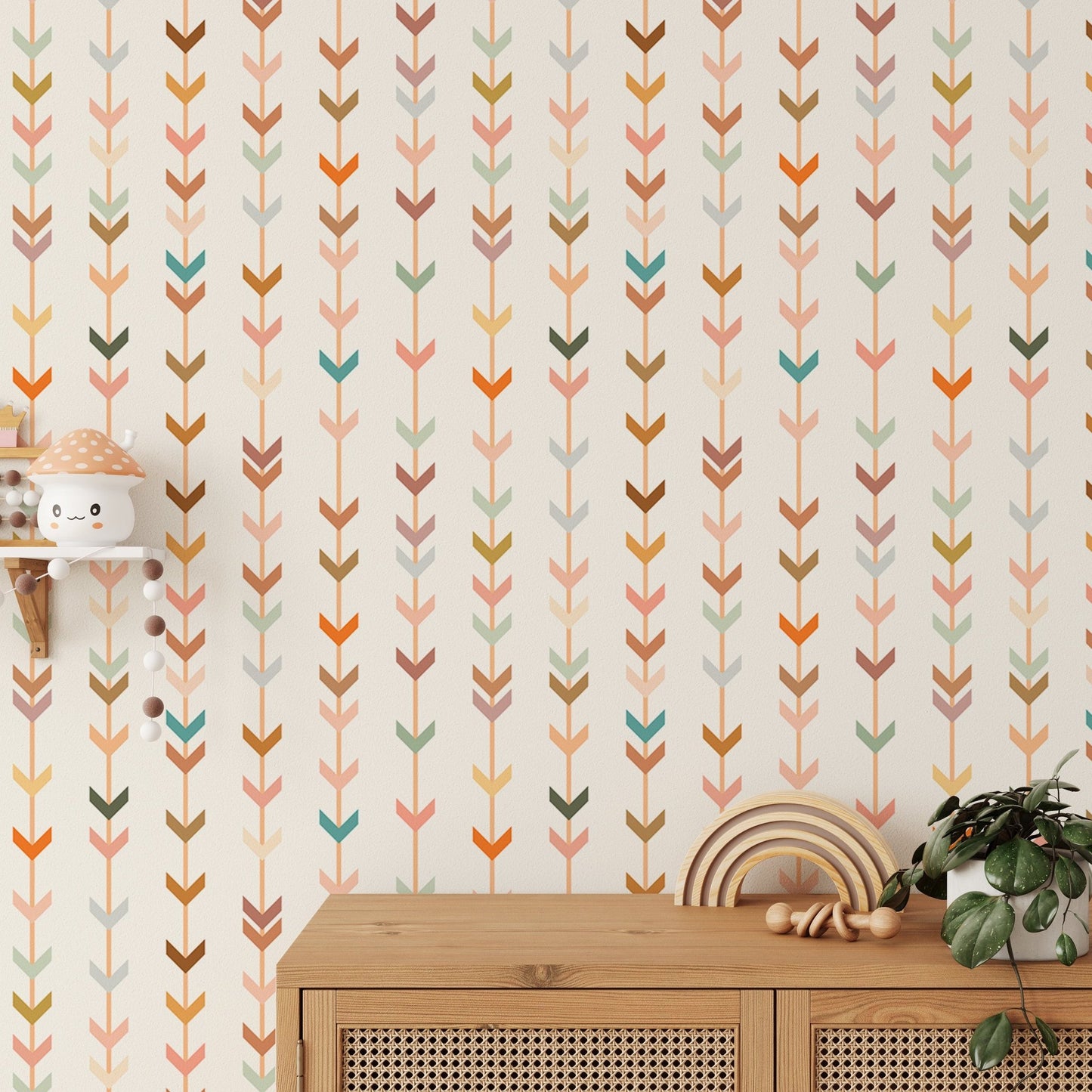 Nursery wall featuring geometric patterns on wallpaper near a wooden dresser.