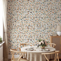 Round dining table set against a mosaic stones background wallpaper.