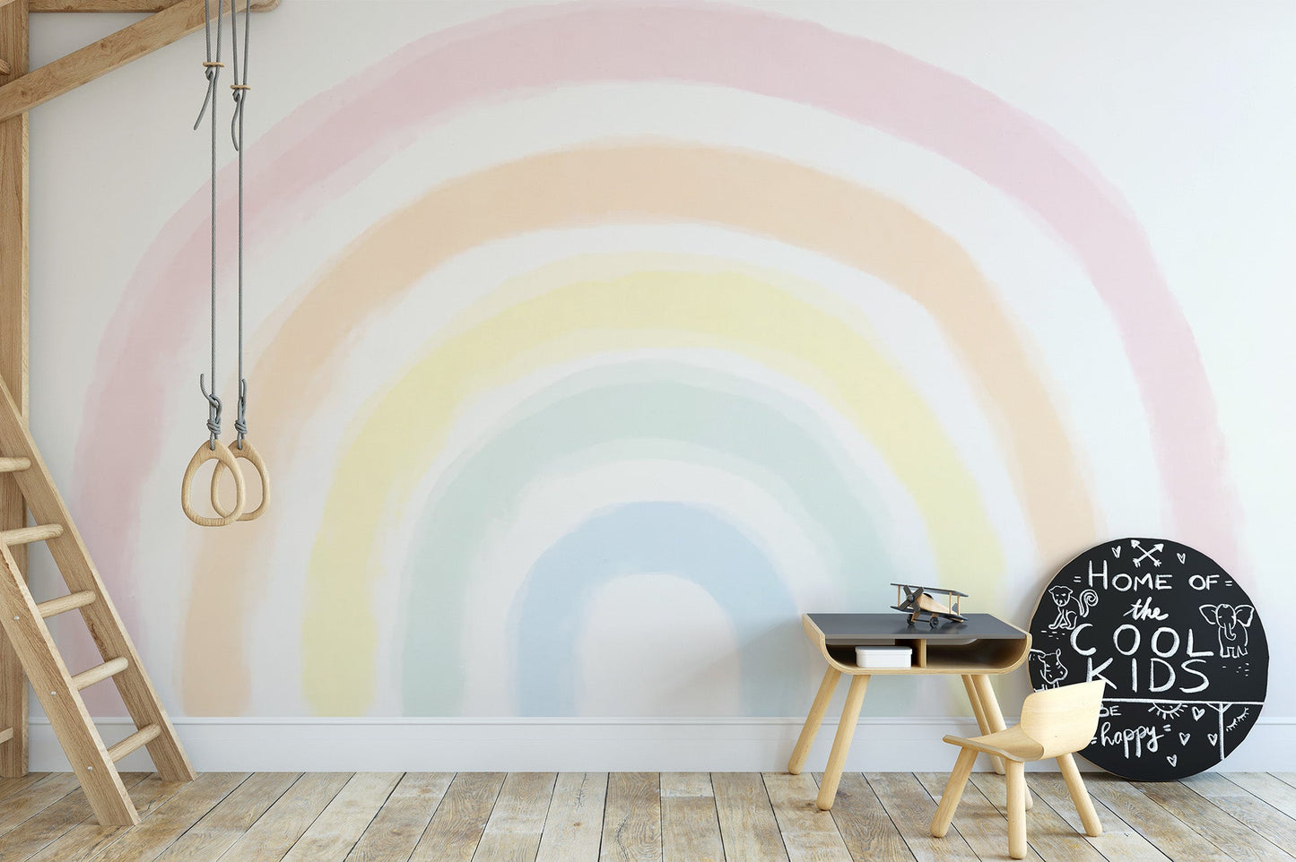 Subtle rainbow wall mural with a faded watercolor effect on a bright backdrop.
