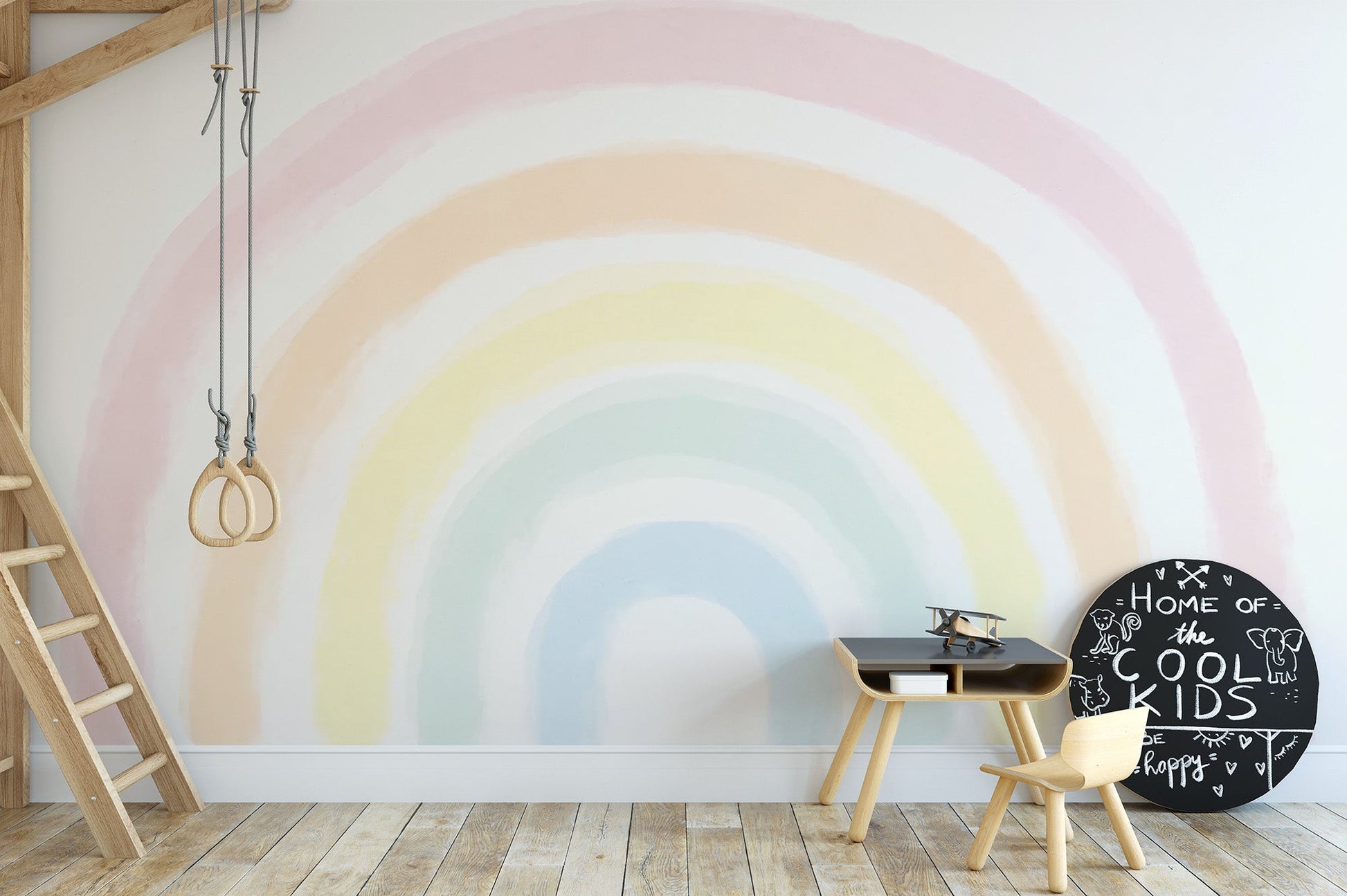 Subtle rainbow wall mural with a faded watercolor effect on a bright backdrop.
