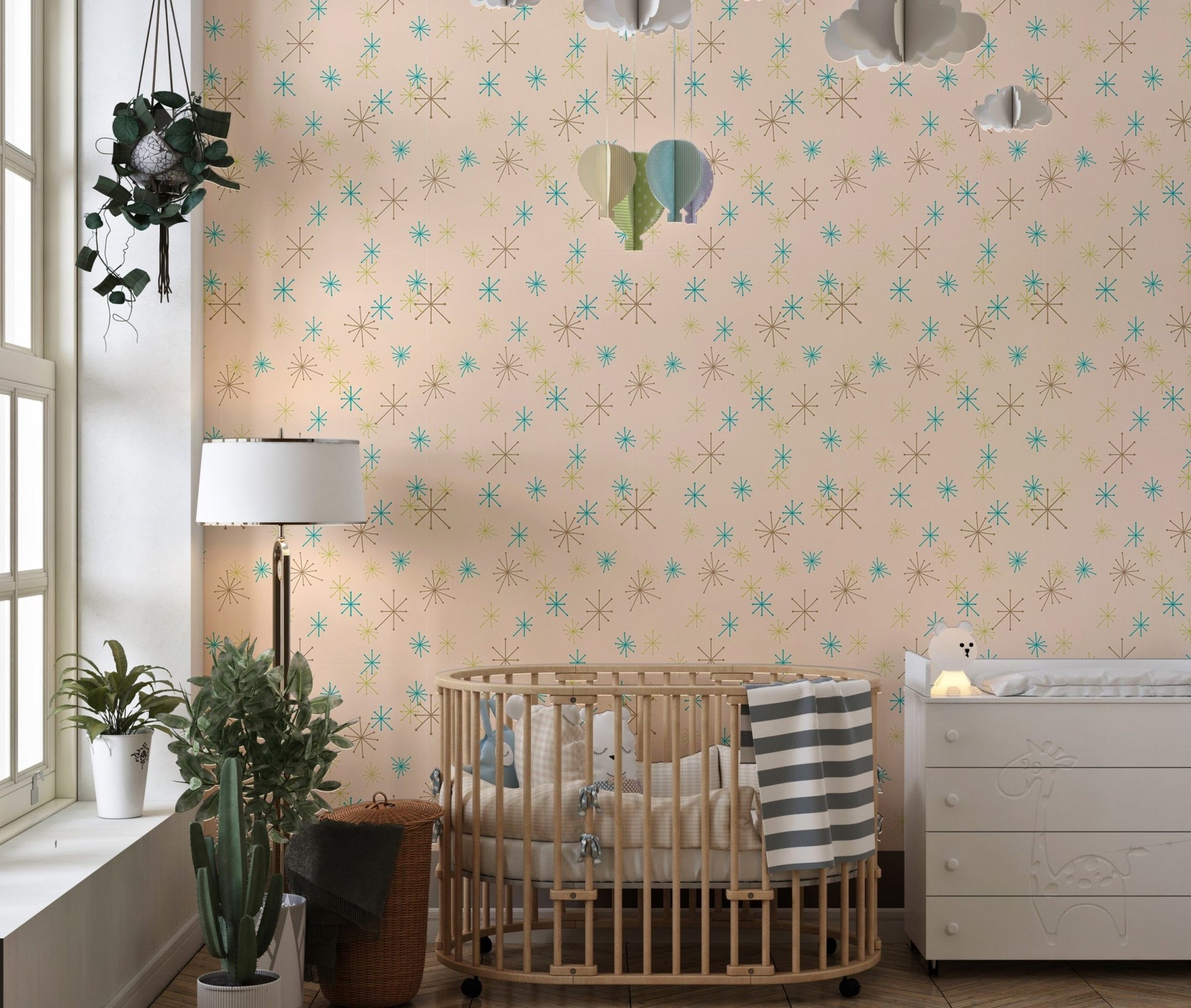 Nursery room featuring a wooden crib and pastel background wall mural with fleck patterns.