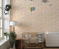 Nursery room featuring a wooden crib and pastel background wall mural with fleck patterns.