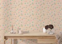 Workspace featuring a light wood desk positioned against a pastel background wall mural.