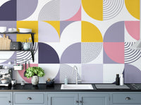 Kitchen backsplash area featuring colorful Swiss geometric shapes wallpaper.