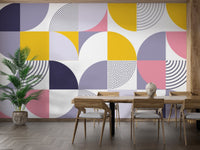 Large scale geometric wallpaper in a dining room with wooden furniture and plants.