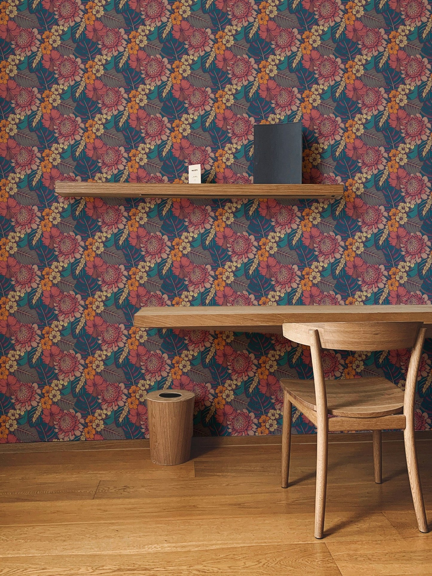 Colorful Tropical Flower Peel and Stick Wallpaper in a study with a wooden chair.