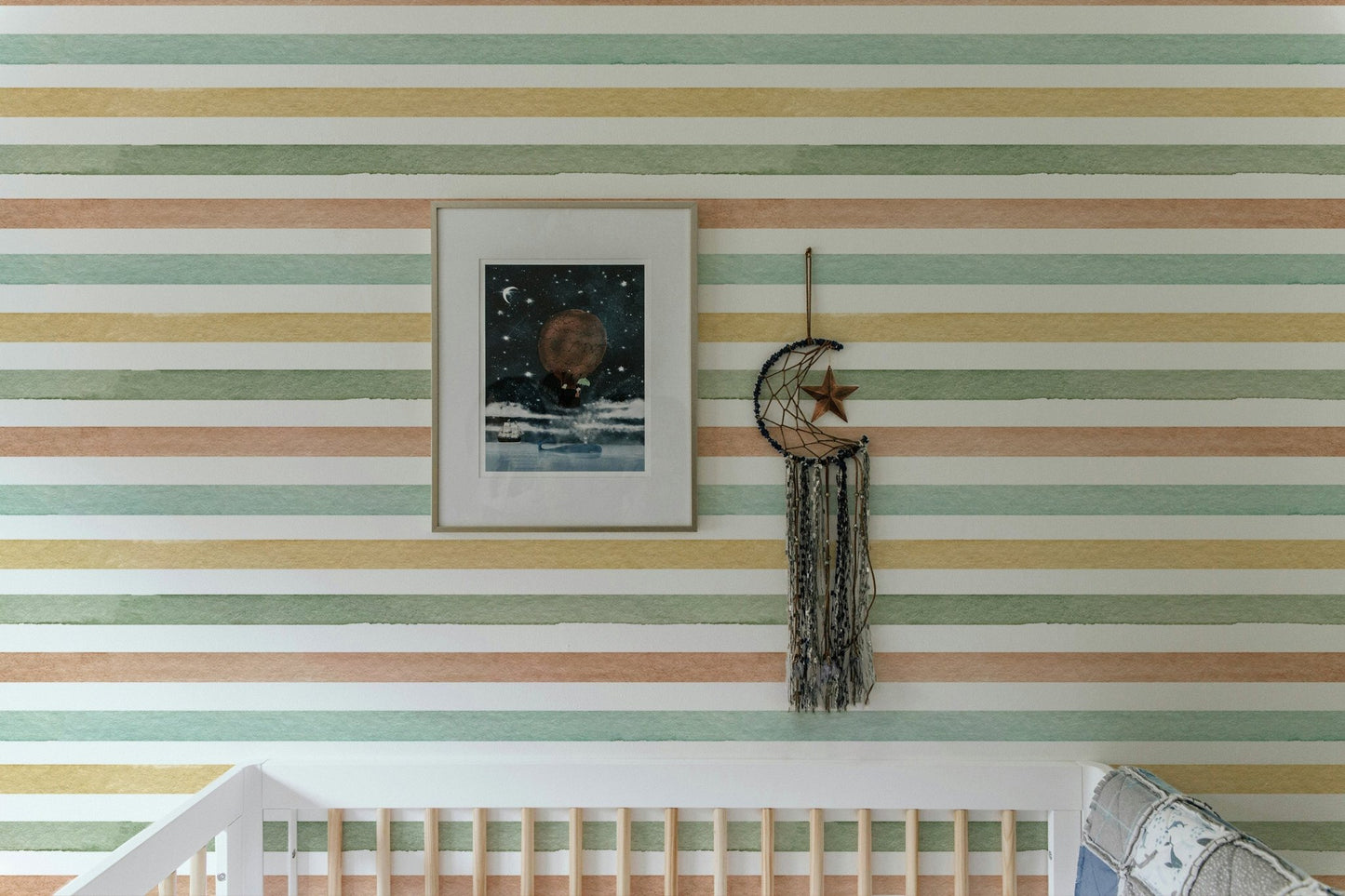Colorful pattern wallpaper in a nursery with a framed picture and wall hanging