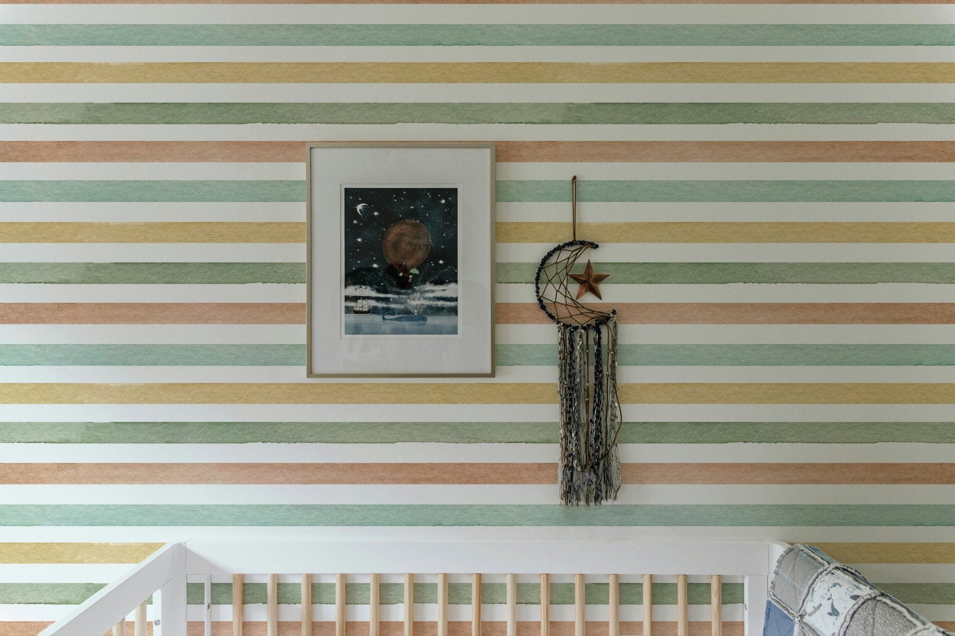 Colorful pattern wallpaper in a nursery with a framed picture and wall hanging
