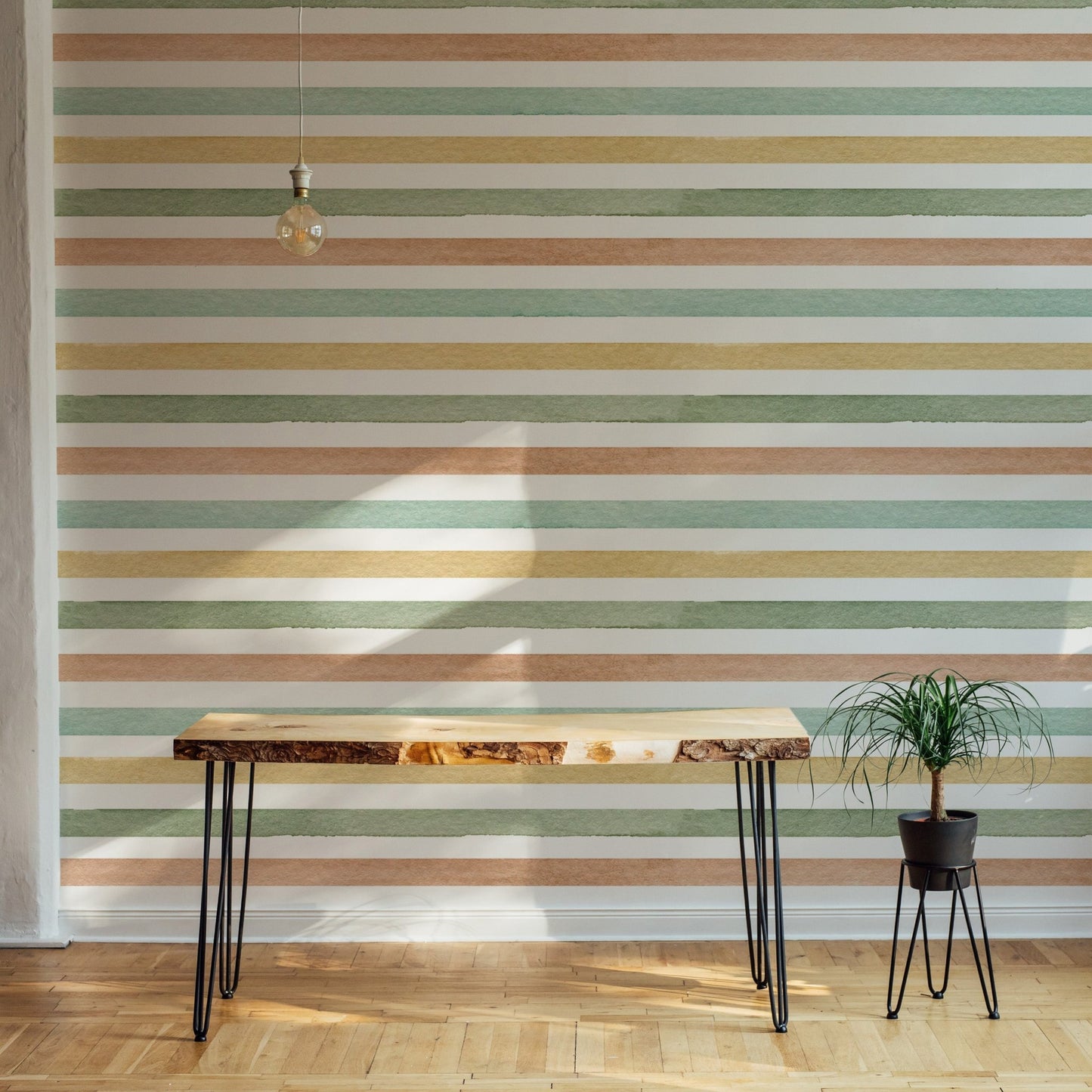 Minimalist workspace featuring green and orange striped wallpaper and wooden desk