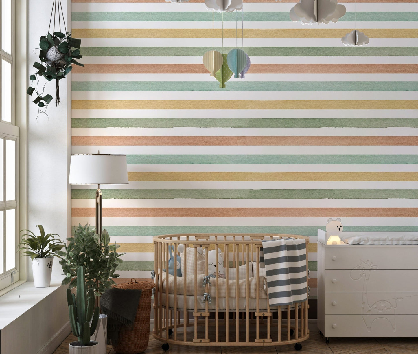 Nursery room wallpaper with horizontal stripes near a wooden cot and lamp