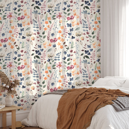 Rustic wallpaper with orange and blue floral patterns behind a bed.