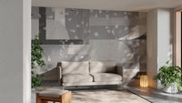 Grey terrazzo wall mural behind a contemporary grey sofa.