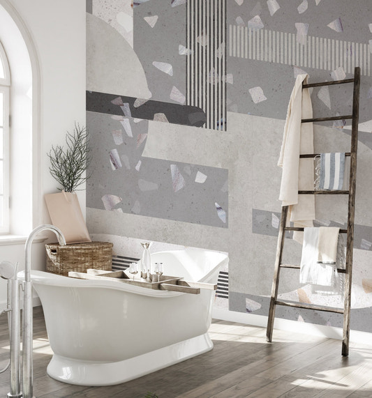 Grey terrazzo bathroom wall mural with white freestanding bathtub.