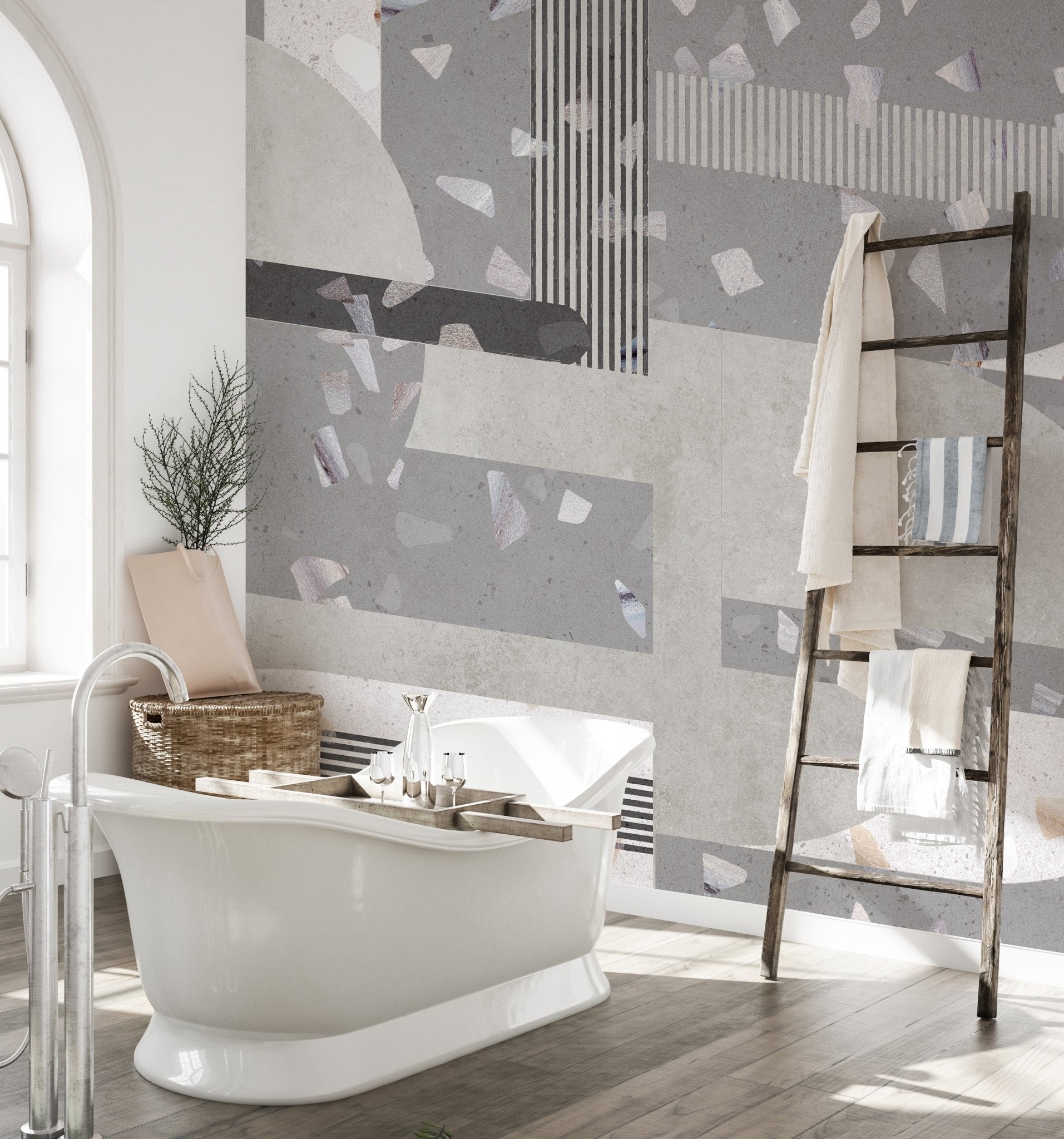 Grey terrazzo bathroom wall mural with white freestanding bathtub.